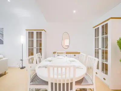 a white dining room with a white table and chairs at TRPS - Marina Heights Tower, Dubai Marina - 2BR Upgraded Apartment - with Stunning Marina Skyline in Dubai