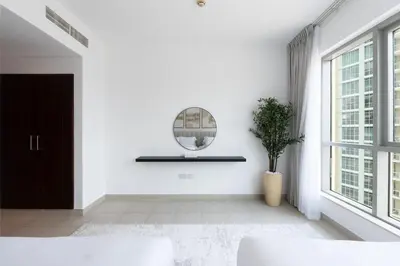 a white room with a mirror and a potted plant at 2 Bedroom Apartment BLVD Central 1 with Boulevard Views in Dubai
