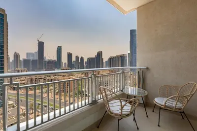a balcony with chairs and a view of the city at 2 Bedroom Apartment BLVD Central 1 with Boulevard Views in Dubai