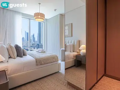 a bedroom with a bed and a large window at HiGuests - Wake up to Burj Khalifa views in stunning 2 BR in Dubai