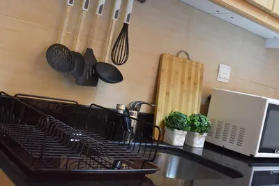 a kitchen with a counter with a stove and a laptop at Relaxing and luxurious studio-Dubai in Dubai