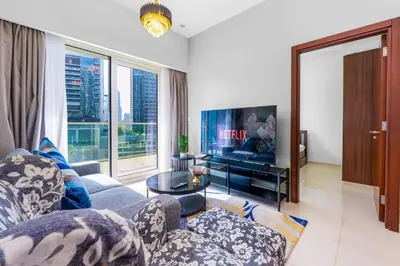 a living room with a couch and a tv at Business Bay 2 Bedroom with Burj Khalifa Views in Dubai