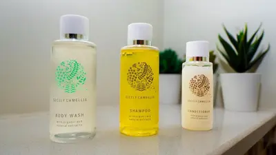 three bottles of essential oils sitting on a counter at Business Bay 2 Bedroom with Burj Khalifa Views in Dubai