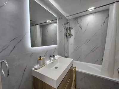 a bathroom with a sink and a shower and a mirror at Luxury 1BR by dubai marina walk! in Dubai