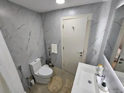 a bathroom with a white toilet and a sink at Luxury 1BR by dubai marina walk! in Dubai
