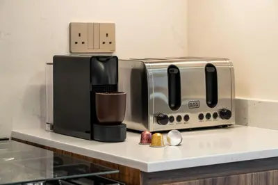 a toaster and a coffee maker on a counter at Seraya at Grande Signature Residences in Dubai