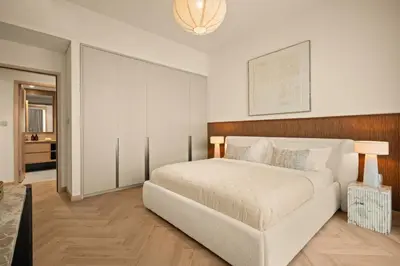 a bedroom with a large white bed in a room at Seraya at Grande Signature Residences in Dubai