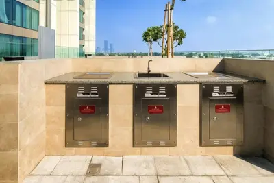 an outdoor kitchen with a sink on a building at Burj Khalifa Views at Downtown Views II 3 Bedroom Apartment in Dubai
