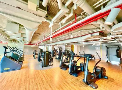 a gym with treadmills and elliptical machines at Burj Khalifa Views at Downtown Views II 3 Bedroom Apartment in Dubai