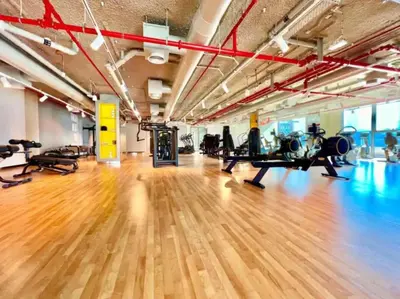 a gym with a wooden floor and tread machines at Downtown Views II 2 Bedroom Apartment Next to Dubai Mall in Dubai