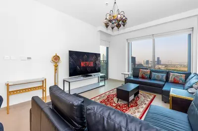 a living room with a couch and a tv at Downtown Views II 2 Bedroom Apartment Next to Dubai Mall in Dubai