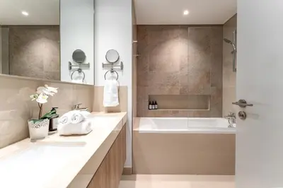 a bathroom with a tub and a sink at Stunning Corner 2 Bedroom in Downtown Views II in Dubai