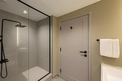 a bathroom with a shower and a glass shower door at Stylish Studio in Meydan 10mins away Burj Khalifa in Dubai