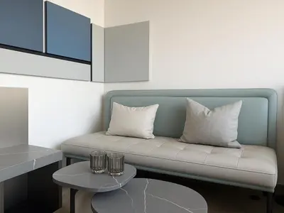 a living room with a couch and a table at Modern Studio in Meydan - Minutes from Dubai Mall in Dubai