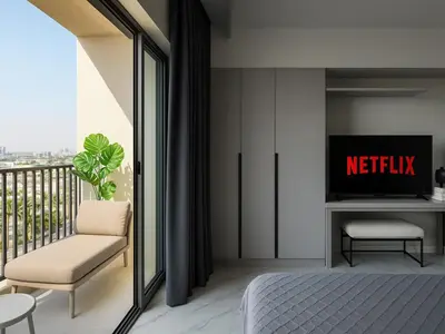 a bedroom with a bed and a tv and a balcony at Modern Studio in Meydan - Minutes from Dubai Mall in Dubai