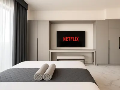 a bedroom with a bed and a tv on a wall at Modern Studio in Meydan - Minutes from Dubai Mall in Dubai