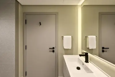 a bathroom with a white sink and a mirror at Modern Studio in Meydan - Minutes from Dubai Mall in Dubai
