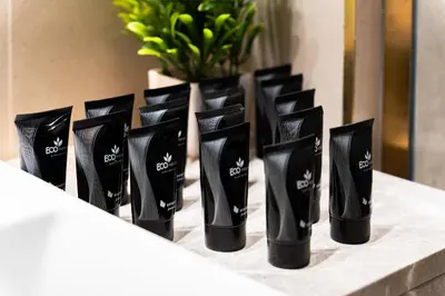 a row of black bottles sitting on a counter at SettlerHomes - Private Jacuzzi Oasis on the High-Floor in Dubai