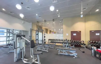 a gym with rows of treadmills and machines at Duplex Penthouse on 73rd Floor in Dubai Marina in Dubai