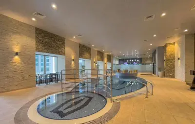 a lobby with a pool in the middle of a building at Duplex Penthouse on 73rd Floor in Dubai Marina in Dubai