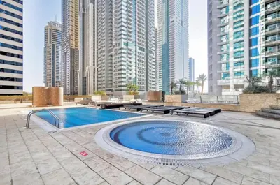 a pool in the middle of a city with tall buildings at Duplex Penthouse on 73rd Floor in Dubai Marina in Dubai