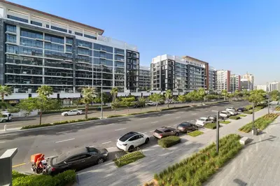 a city street with cars parked in a parking lot at Stylish 1BR near Business Bay, Meydan Racecourse & Crystal Lagoon in Dubai