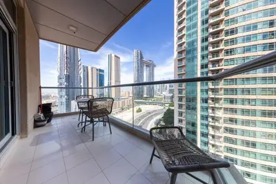 a balcony with chairs and a view of a city at The Lofts, Burj Khalifa View in Dubai