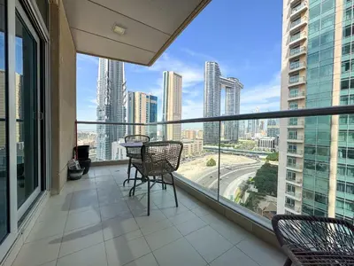 a balcony with chairs and a view of a city at The Lofts, Burj Khalifa View in Dubai
