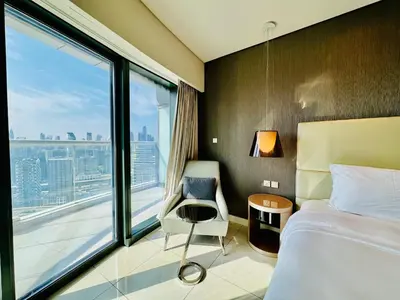 a hotel room with a bed and a large window at Luxe 3BR , Paramount by DAMAC, Excellent Pool in Dubai
