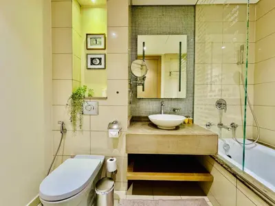 a bathroom with a sink and a toilet and a tub at Luxe 3BR , Paramount by DAMAC, Excellent Pool in Dubai