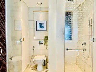 a bathroom with a toilet and a shower at Luxe 3BR , Paramount by DAMAC, Excellent Pool in Dubai