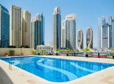 a large swimming pool in front of a city skyline at Best View in Marina Dubai in Dubai