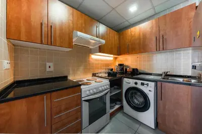 a kitchen with a stove and a washing machine at Best View in Marina Dubai in Dubai