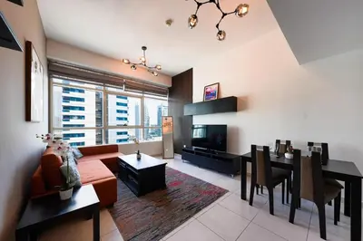 a living room with a couch and a dining room at Best View in Marina Dubai in Dubai