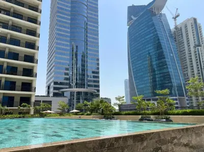 a swimming pool in a city with tall buildings at FIRST CLASS 1BR Contemporary Comfort in Dubai