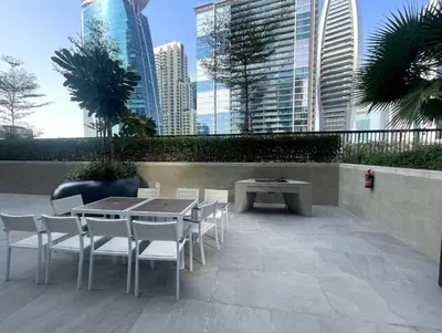 a patio with a table and chairs and buildings at FIRST CLASS 1BR Contemporary Comfort in Dubai
