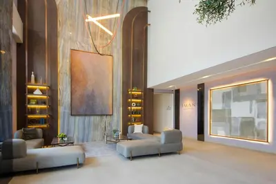 a lobby with couches and chairs in a building at Modern Loft Studio JVC ,Stylish & Fully Furnished in Dubai