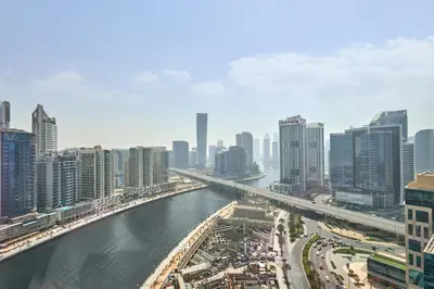 a view of a city with a river and buildings at Charming Studio with Scenic Canal Views in Dubai