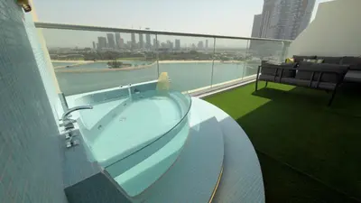 a hot tub on the balcony of a building at Highend Azure 1BR Sea View and Private Beach with Pool Access in Dubai