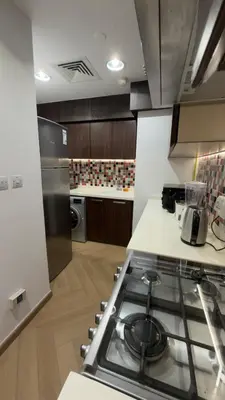 a kitchen with a stove top oven in a kitchen at Highend Azure 1BR Sea View and Private Beach with Pool Access in Dubai