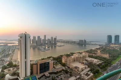 an aerial view of a city with a river and buildings at Luxe 3-Bedroom Sky Retreat in Dubai Marina in Dubai