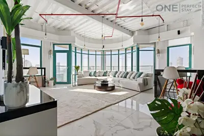 a living room with white furniture and glass windows at Luxe 3-Bedroom Sky Retreat in Dubai Marina in Dubai