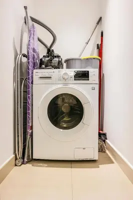 a white washing machine sitting in a room at FIRST CLASS 1BR Stylish Gem Near Dubai Mall in Dubai
