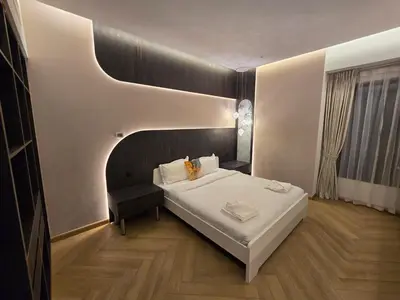 a bedroom with a large white bed and a chair at Highend 2BR Skyline View with Beach JBR in Dubai