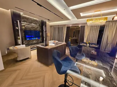a living room with a lobby with blue chairs at Highend 2BR Skyline View with Beach JBR in Dubai