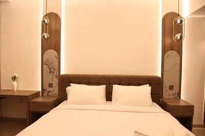 a bed with a wooden headboard and white pillows at Highend 2BR Sea and Beach View in Dubai