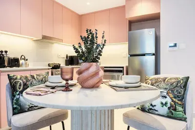 a kitchen with a table with a vase on it at FIRST CLASS 1BR Classic Luxe Getaway in Dubai