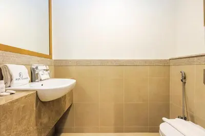 a bathroom with a sink and a toilet at Stylish 2BR Downtown Dubai with Skyline & Burj Khalifa Views in Dubai