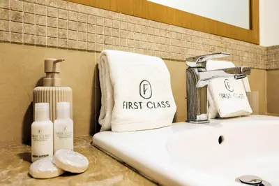 a bathroom sink with a first glass towel on it at Stylish 2BR Downtown Dubai with Skyline & Burj Khalifa Views in Dubai