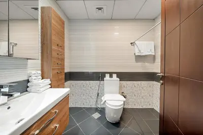 a bathroom with a toilet and a sink at FIRST CLASS Studio Elegant Escape, Cozy Luxe in Dubai